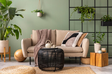 The stylish composition at living room interior with design beige sofa, black coffee table, plants...