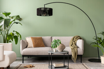 The stylish composition at living room interior with green wall, design gray sofa, coffee table,...