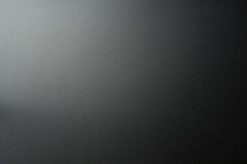 Black matte plastic background with texture and lighting.