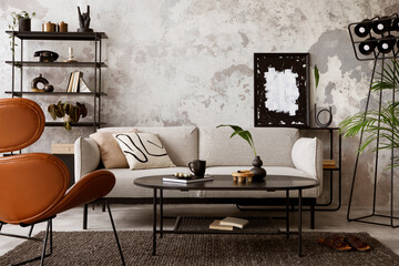 The stylish compostion at living room interior with design gray sofa, armchair, black coffee table, lamp and elegant personal accessories. Loft and industrial interior. Template.