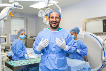 Portrait of male surgeon standing in operating room, ready to work on a patient. Male medical...