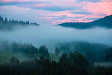 Foggy landscape between the mountains early in the morning