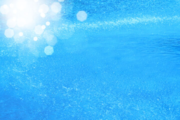 Fototapeta na wymiar 爽快な水しぶきとレンズフレア　全面ライトブルーの背景