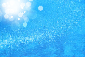 Fototapeta na wymiar 爽快な水しぶきとレンズフレア　全面ライトブルーの背景