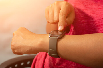 Women look at smartwatches or sport watch, checking distance and heart rate.
