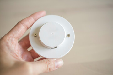 LED lamp in the hands of a girl. Electricity, lighting. Import, Chinese production of diode lamps.