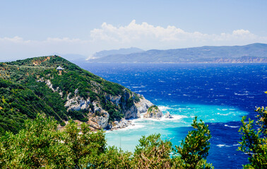 Obraz premium Mediterranean hidden places at Kastro, Skiathos island, Greece. Beautiful vivid panorama view of blue aegean sea coast from wild cliff. Summer holiday vacation tour.
