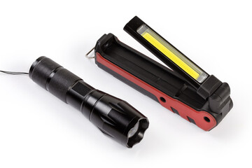 Two different modern electric LED flashlights on a white background