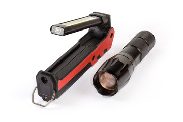 Two different modern electric LED flashlights on a white background