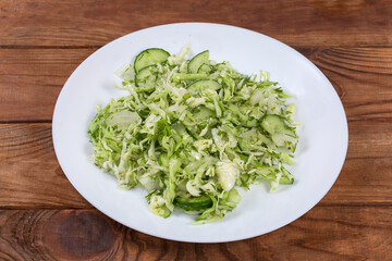 Green spring vegetable salad on dish on a rustic table