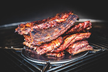 Stack of grilled pork ribs in grill
