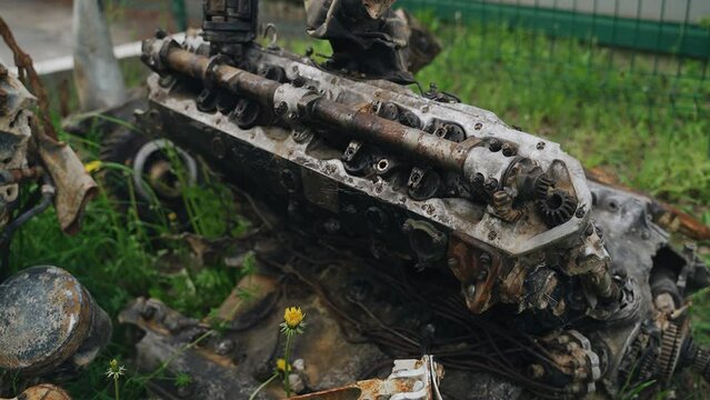 An internal combustion engine from an old military aircraft lifted out of the ground. The aircraft took part in the Second World War