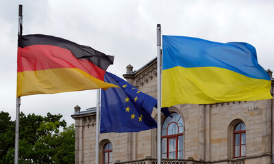 The flags of Ukraine, Germany, and the EU waving in the wind