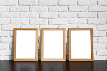 Blank picture frame against brick wall with copy space