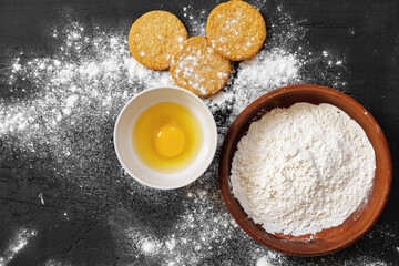 Preparation for baking. Eggs and flour on black background