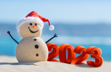 Sandy Snowmen is celebrating the New Year on a beautiful beach with 2023 3d text, concept for new year 2023