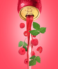 Red drink pours from a metal bottle with raspberries and leaves
