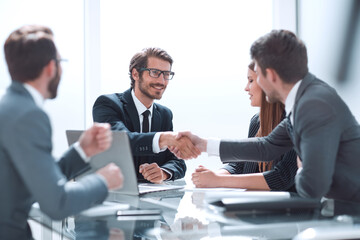 Fototapeta premium business partners reach out to each other for a handshake