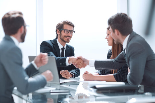 Business Partners Reach Out To Each Other For A Handshake