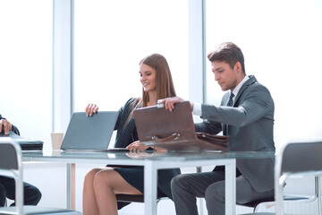 businessman and businesswoman sitting at his Desk