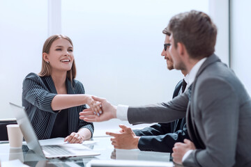 Business people shaking hands over the Desk