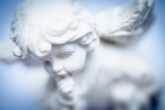 Little beautiful guardian angel on a light background. Horizontal image.