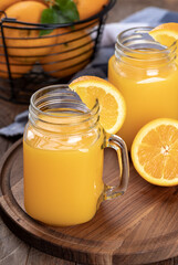 Two glasses of orange juice with orange slices
