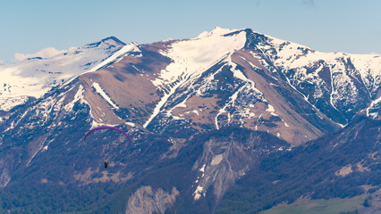 amazing shot of paragliding in the snowcapped Caucasus Mountains, Gudauri, Georgia. High quality photo