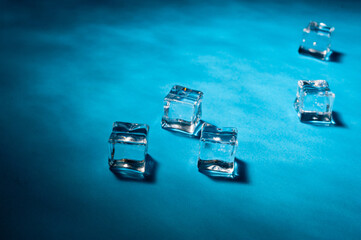 Clear ice cubes for cooling drinks on a blue background.
