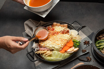 Korean instant noodle and Tteokbokki in spicy sauce, Rabokki - Korean food style with vegetables and seafood.
