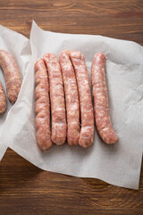 Uncooked homemade butcher sausage for grilling wurst on wrapping paper