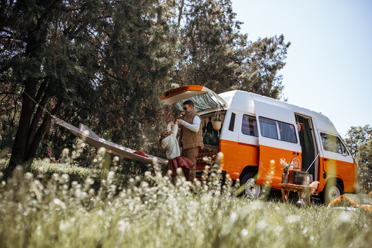 Dad plays and has fun with his daughter on a trip, family vacation. Naughty kids. motorhome, caravan driver, trailer. Traveling with children, fatherhood, father's day