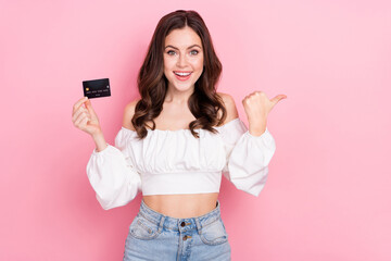 Fototapeta premium Photo of good mood attractive young girl promote recommend banking system isolated on pink color background