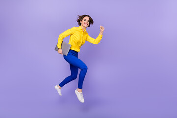Fototapeta na wymiar Full body photo of impressed young brunette lady run with laptop wear shirt trousers footwear isolated on purple background