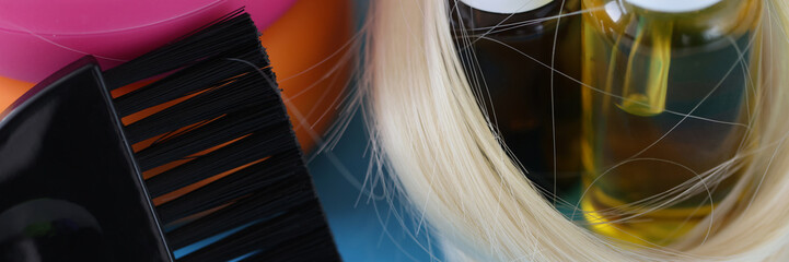 Naklejka premium Bottles with cosmetics for hair care and brush to dye hair