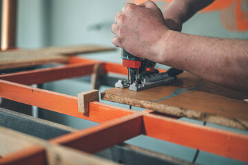 hands holding an electric jigsaw. small business. small business