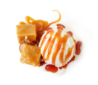 Ice cream ball with caramel cubes and caramel sauce isolated on white. Top view of ice cream.