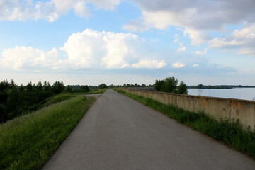Fototapeta na wymiar dam along the river highway blue sky clouds