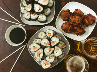 Dinner with sushi and beer and buns