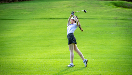Professional woman golfer teeing golf in golf tournament competition at golf course for winner.	