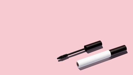 Creative layout of mascara on pink background. Make up products. Copy space.