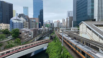 Japanese train tracks and the morning JR train at Ochanomizu station, cloudy weekday year 2022 June 14th, central downtown Tokyo Japan.  
