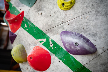 Rock climbing wall with climbing holds in gym