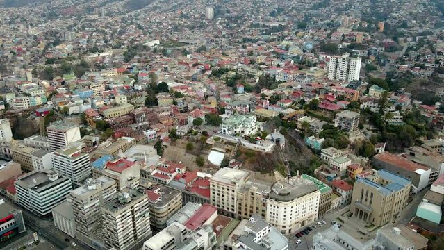 Aerial dolly in of Chilean Army building, Baburizza Palace, Yugoslavian Walk and El Peral funicular in Cerro Alegre, Valparaiso, Chile