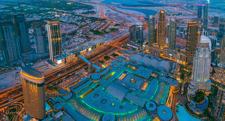 Fototapeta premium Aerial View Of Evening Night Scenic View Of Skyscraper. Night Traffic In Residential District in Dubai. Street Night Illumination. Night Scenic View Of Dubai Skyline. High quality photo.
