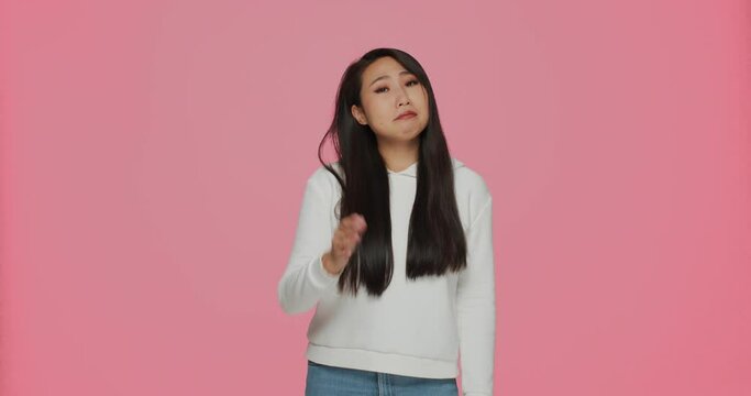 Dissatisfied doubting young asian woman showing so-so gesture. Questionable choice. Unsuitable options concept