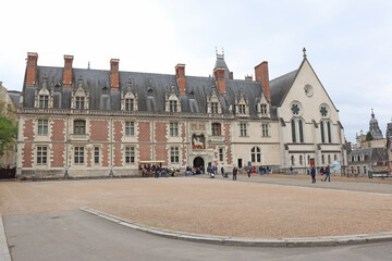 Naklejka premium Blois, France, 04 19 2002 Chateau de Blois. This old Royal castle in Blois, Loire Valley, France. Beautiful scenic view of the castle of Blois on sunny day. Panorama of the Renaissance palace.