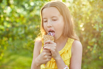 Happy girl with braces eating italian ice cream cone smiling while resting in park on summer day