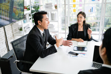 Professional Asian business adviser meeting to analyze and discuss the strategy of financial support of a tech company. Partnership start-up consultant, Indoor business client consultation concept.