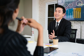 Professional Asian business adviser meeting to analyze and discuss the strategy of financial support of a tech company. Partnership start-up consultant, Indoor business client consultation concept.